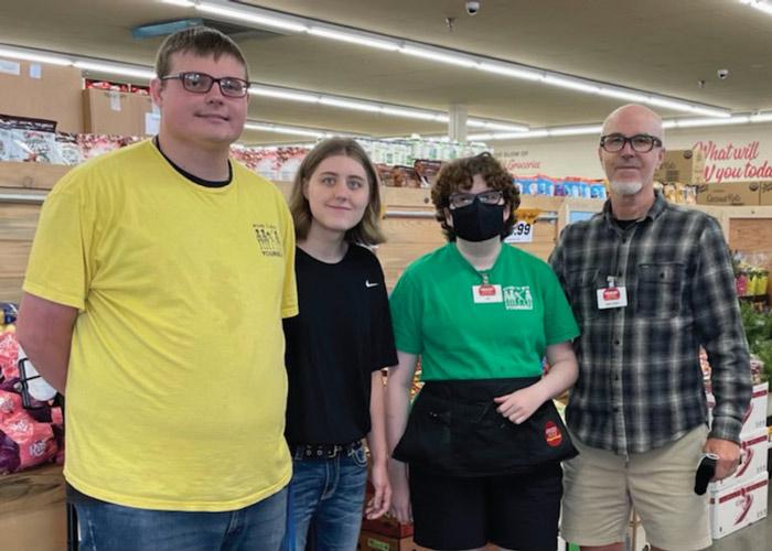 Grocery Outlet co-owner Michael Morgan (far right) poses with some of his employees. About 20 percent of his workforce have some form of disability. He calls hiring those with disabilities “the right thing to do.”