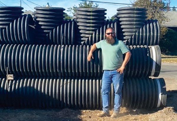 Aaron Fuller stands in front of infiltration gallery pipe at his new office under construction on Kresky Avenue. He said “business is good” and it is time to create more office space for his staff. 