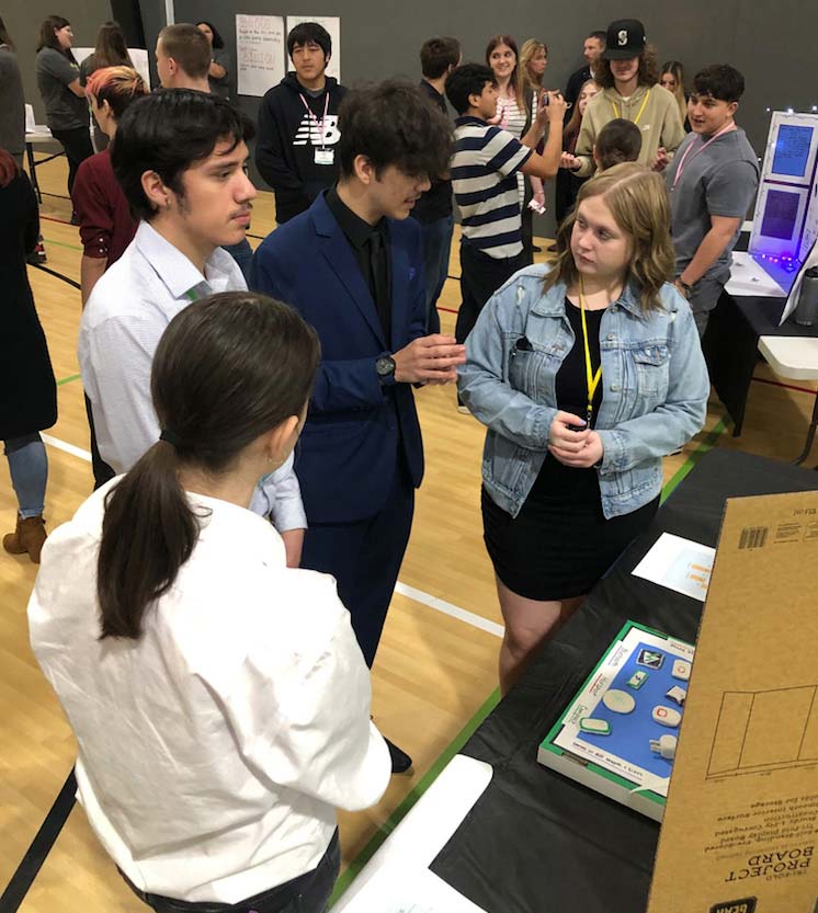 Dolly Tardiff / Economic Alliance of Lewis County Centralia High School students discuss projects during Washington Business Week at the Northwest Sports Hub.