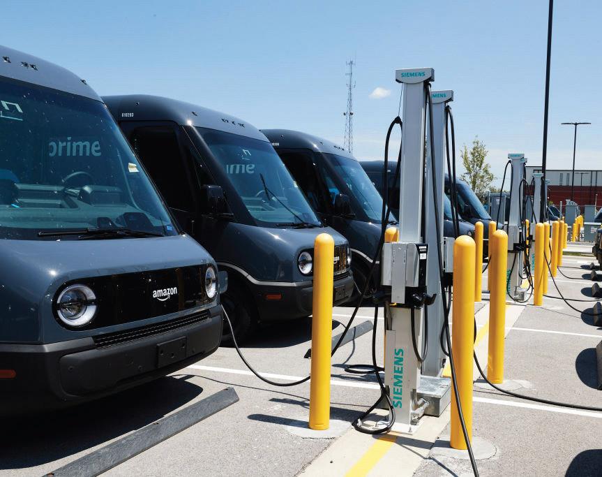 A fleet of electric delivery vehicles charge. A new
network of stations up and down the West Coast
could accelerate the adoption of more electric
vehicles across the region.