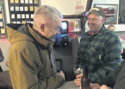 Richard DeBolt, right, chats with Edward Jones Financial Advisor Derek Burger during Tuesday’s retirement celebration